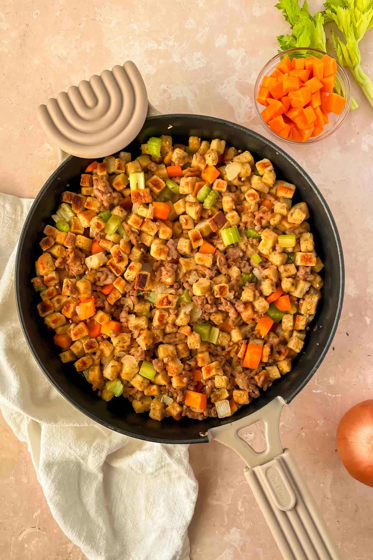 stove top stuffing with sausage with broiled top in tan skillet.