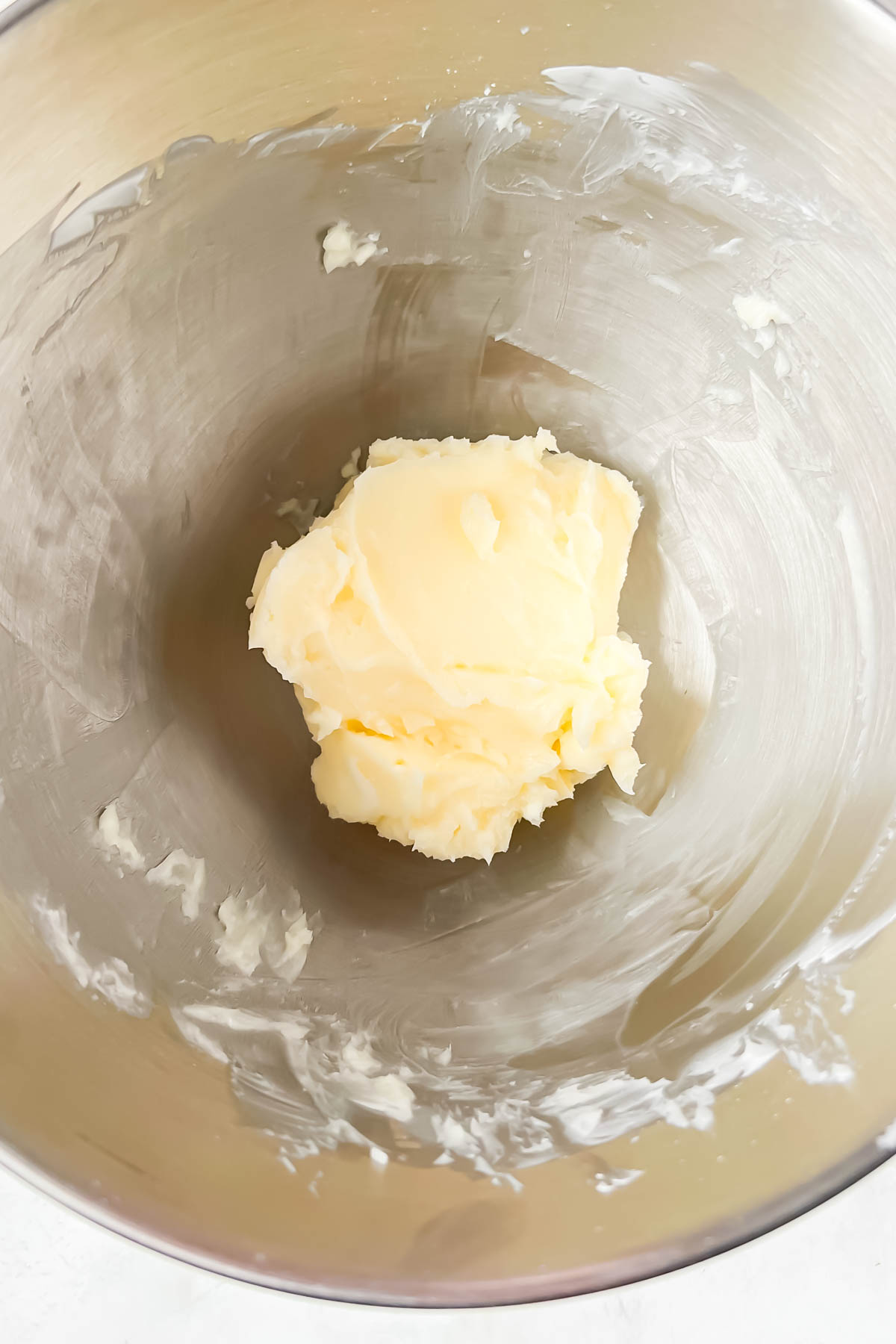 butter in silver stand mixer mixing bowl.