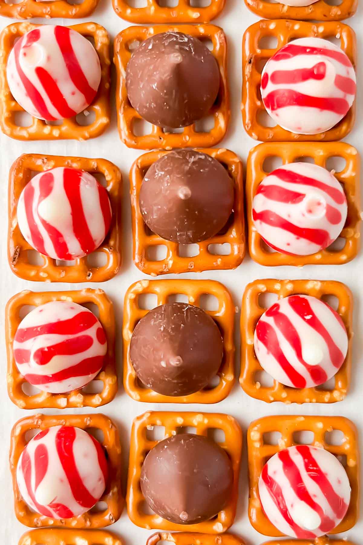 square pretzels topped with hershey kisses.