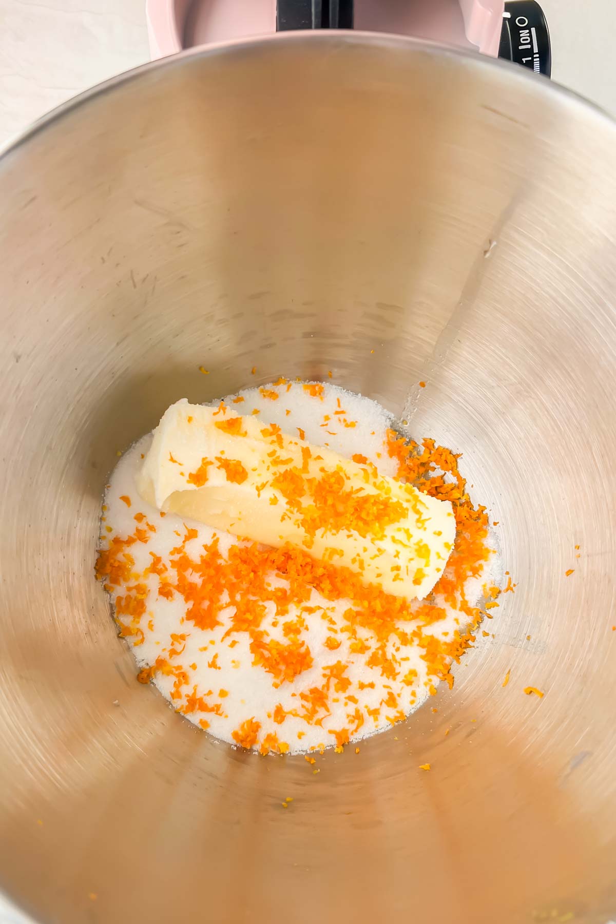 butter, orange zest and sugar in bowl of stand mixer.