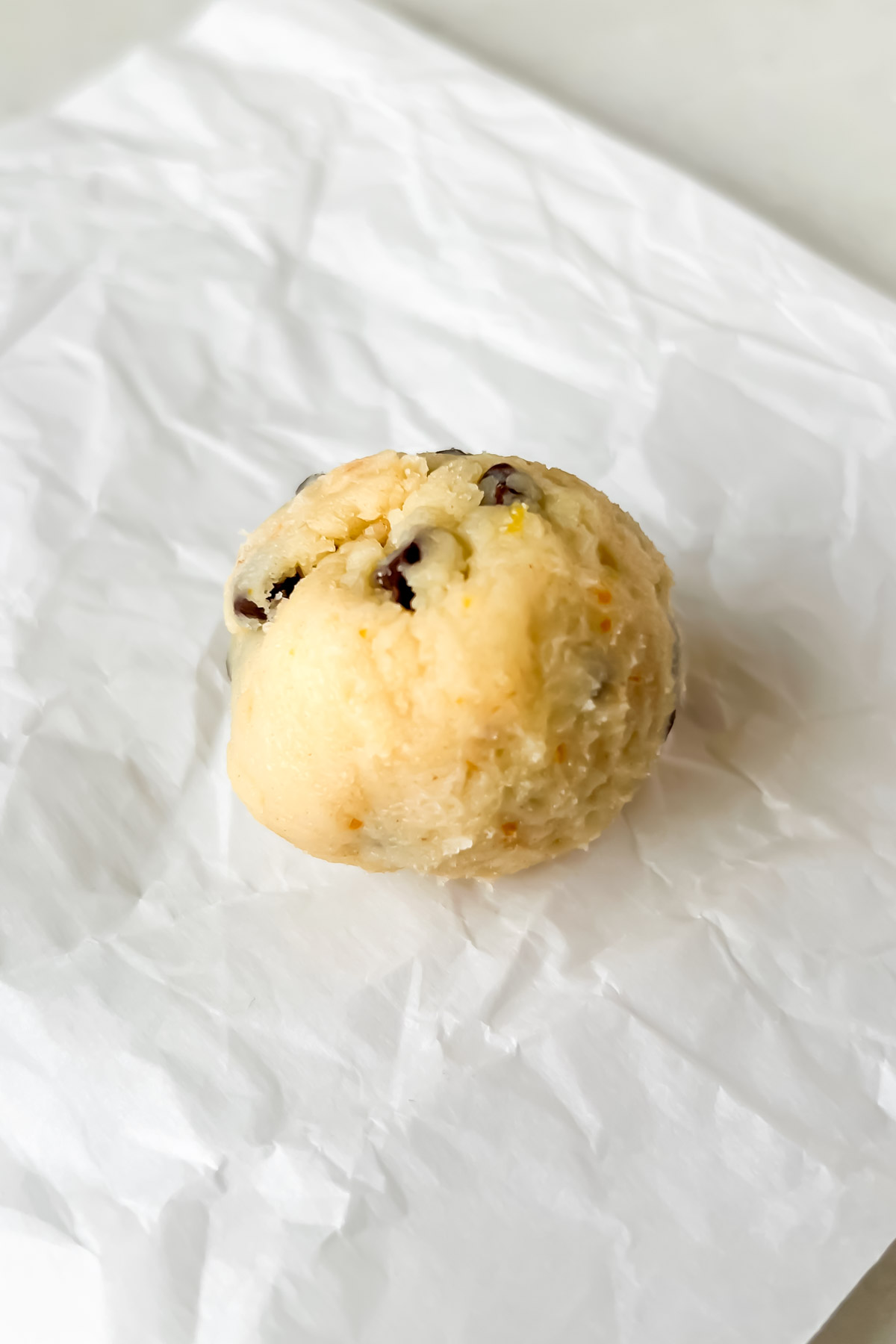 ricotta chocolate chip cookie dough ball on parchment.