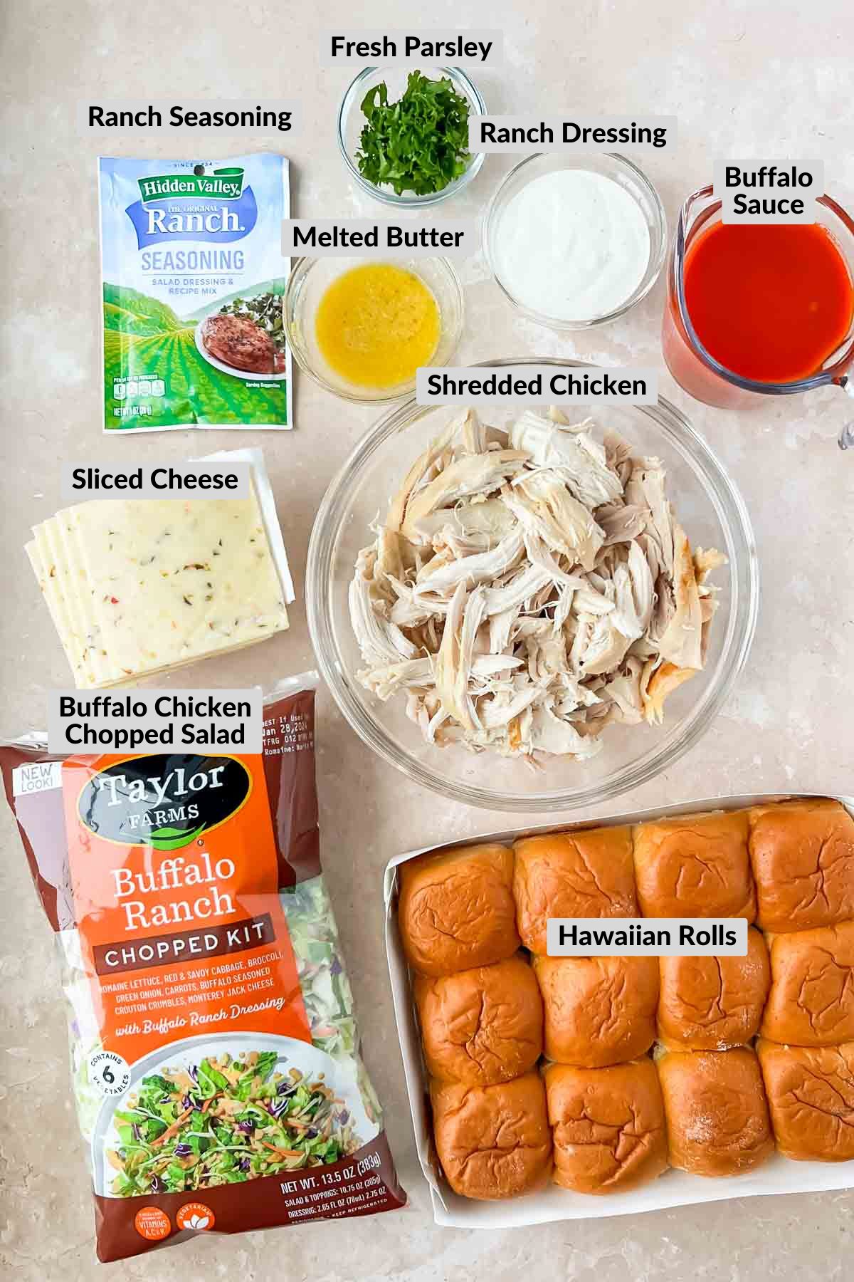 labeled ingredients in individual bowls for buffalo chicken sliders.