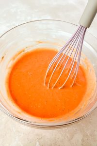 buffalo sauce and whisk in glass mixing bowl.