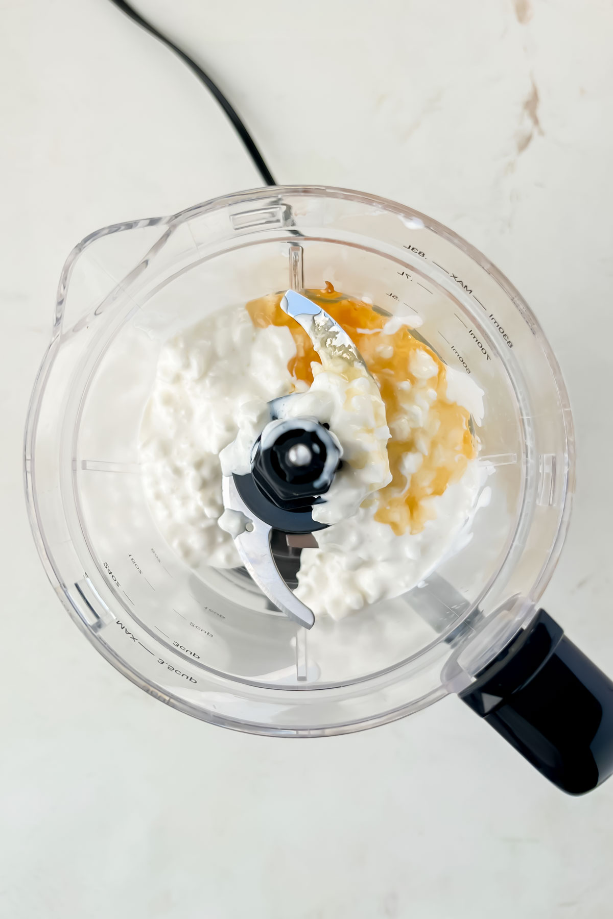 cottage cheese and honey in food processor.