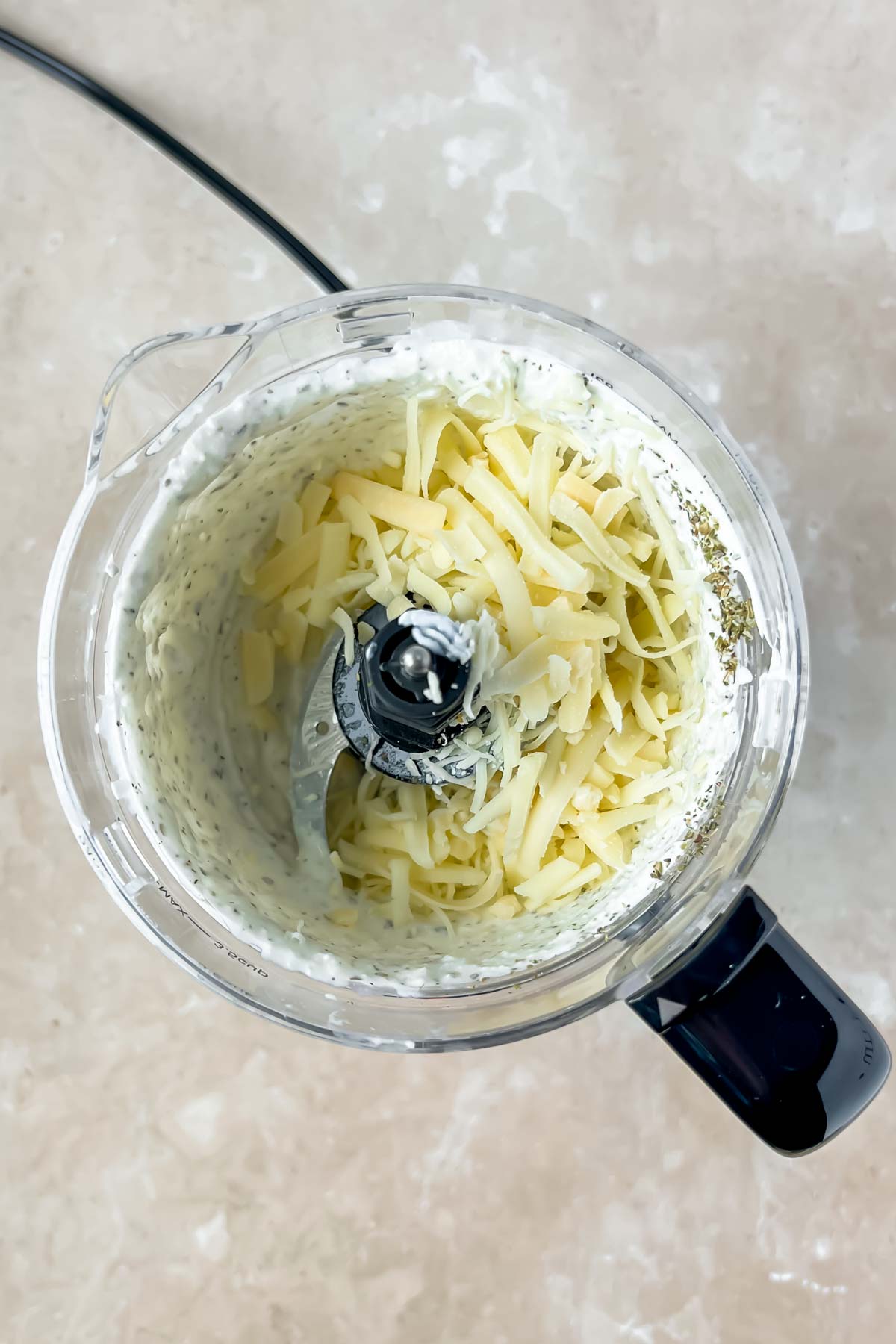 whipped cottage cheese with shredded cheese in food processor.