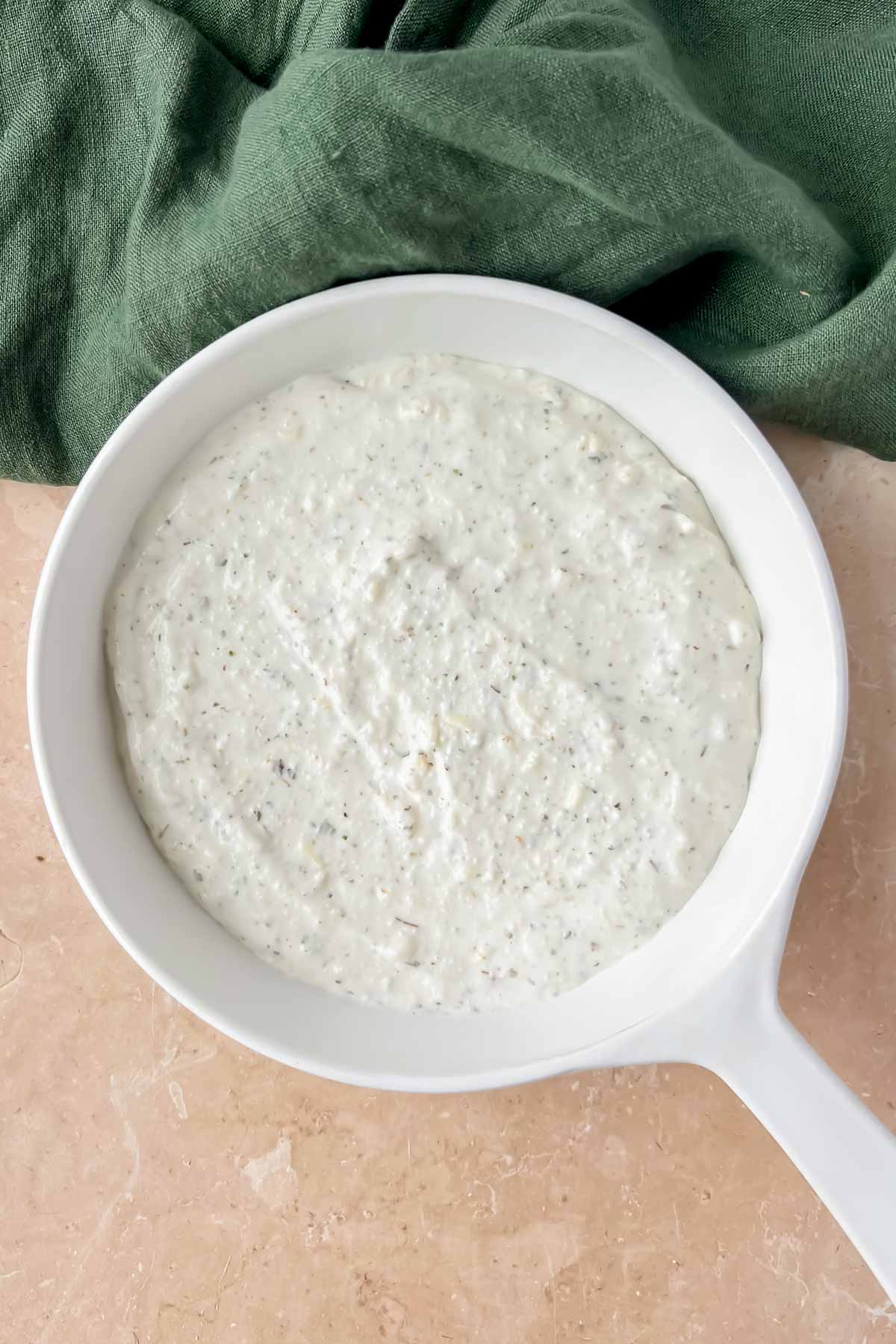 creamy cottage cheese dip in white skillet.