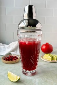 pomegranate moscow mule in cocktail shaker with ice.