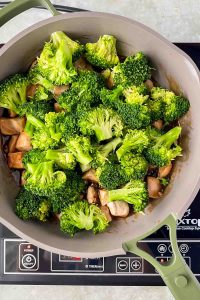 broccoli added to pan with chicken and teriyaki sauce.