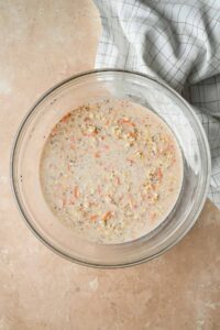 mixed carrot cake overnight oats in glass bowl.