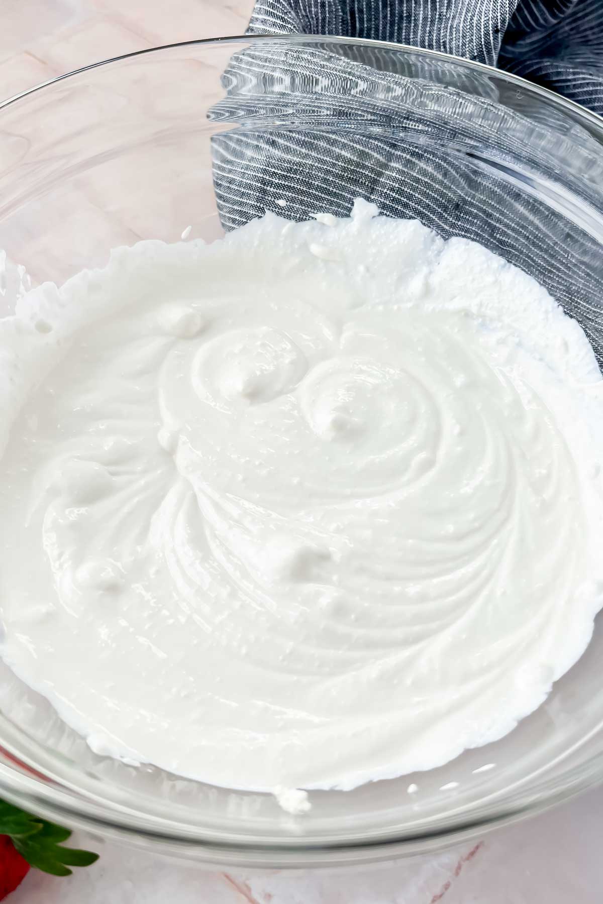 whipped cottage cheese in glass mixing bowl.
