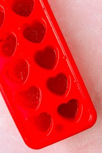 heart molds filled with rosé jello shot mixture.
