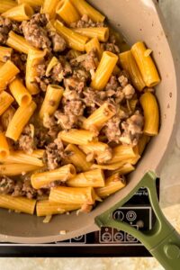 pasta and ground meat mixture in gray skillet.
