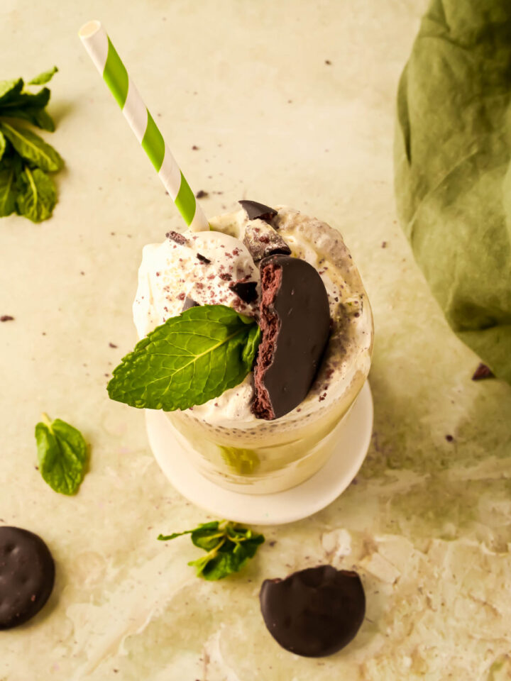 chocolate mint smoothie garnished with a thin mint cookie and mint leave.