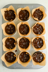 12 not baked One Bowl Double Chocolate Banana Muffins in a muffin tin.