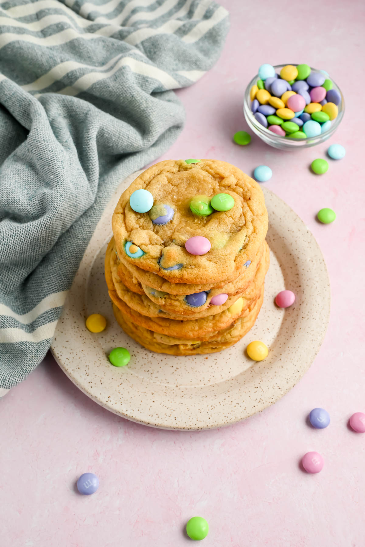 easter M&M cookies stacked in a tower on white plate.