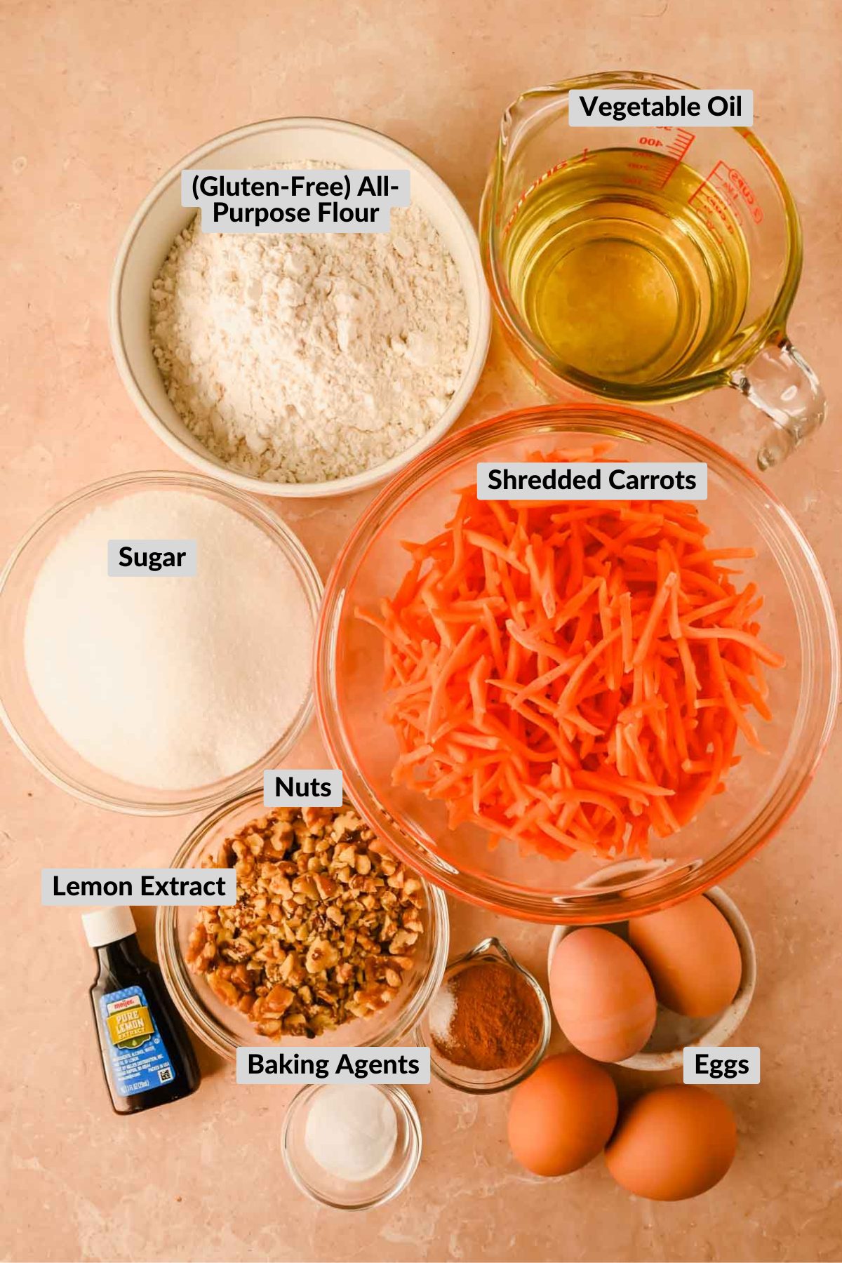 carrot cake ingredients in separate bowls on orange background. 