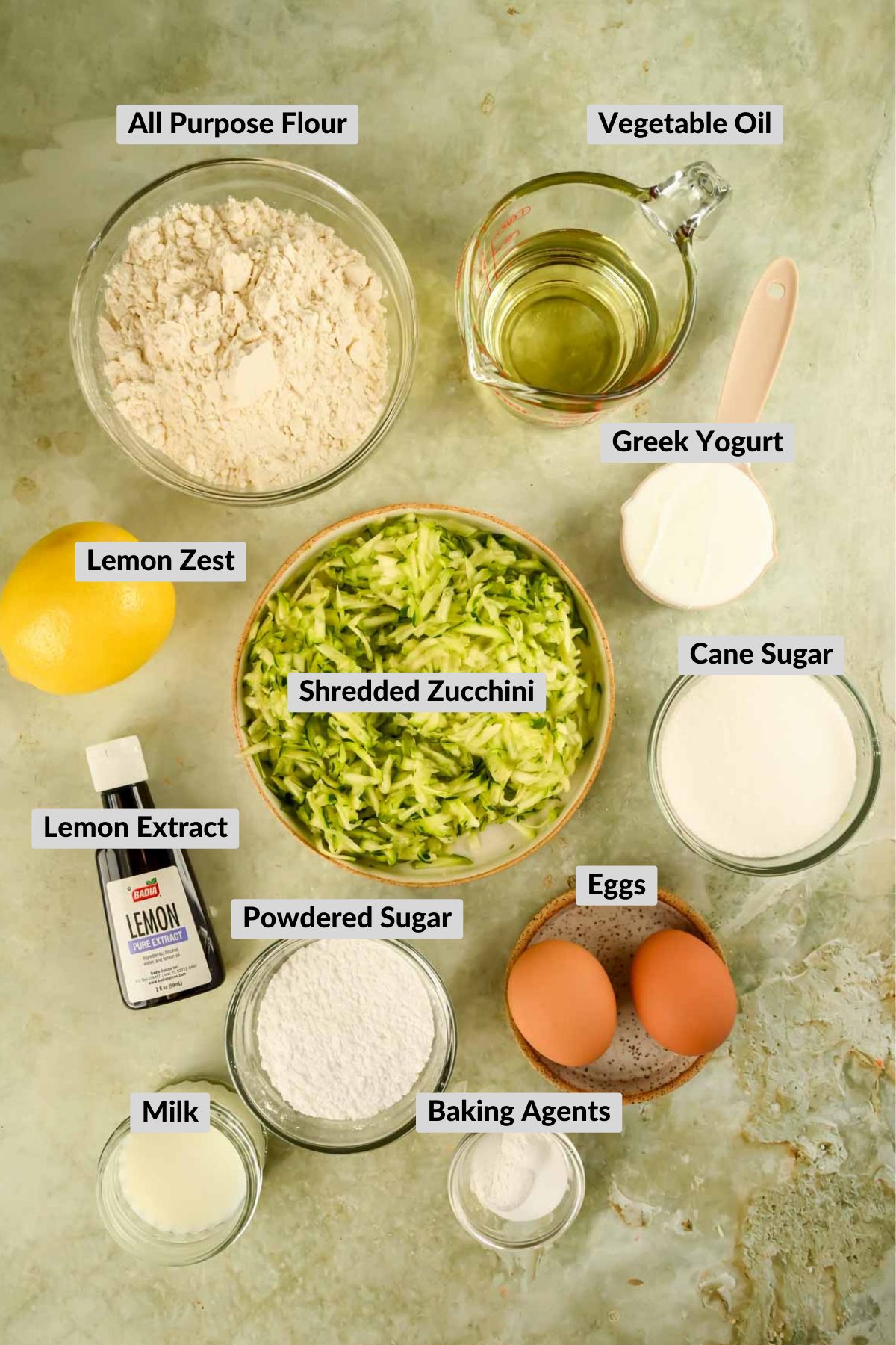 ingredients for lemon zucchini cake in individual bowls.