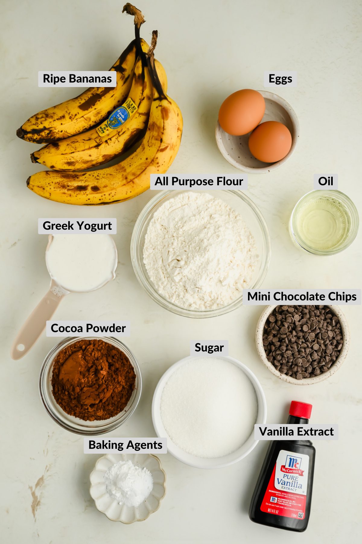 ingredients for double chocolate banana muffins in individual bowls.