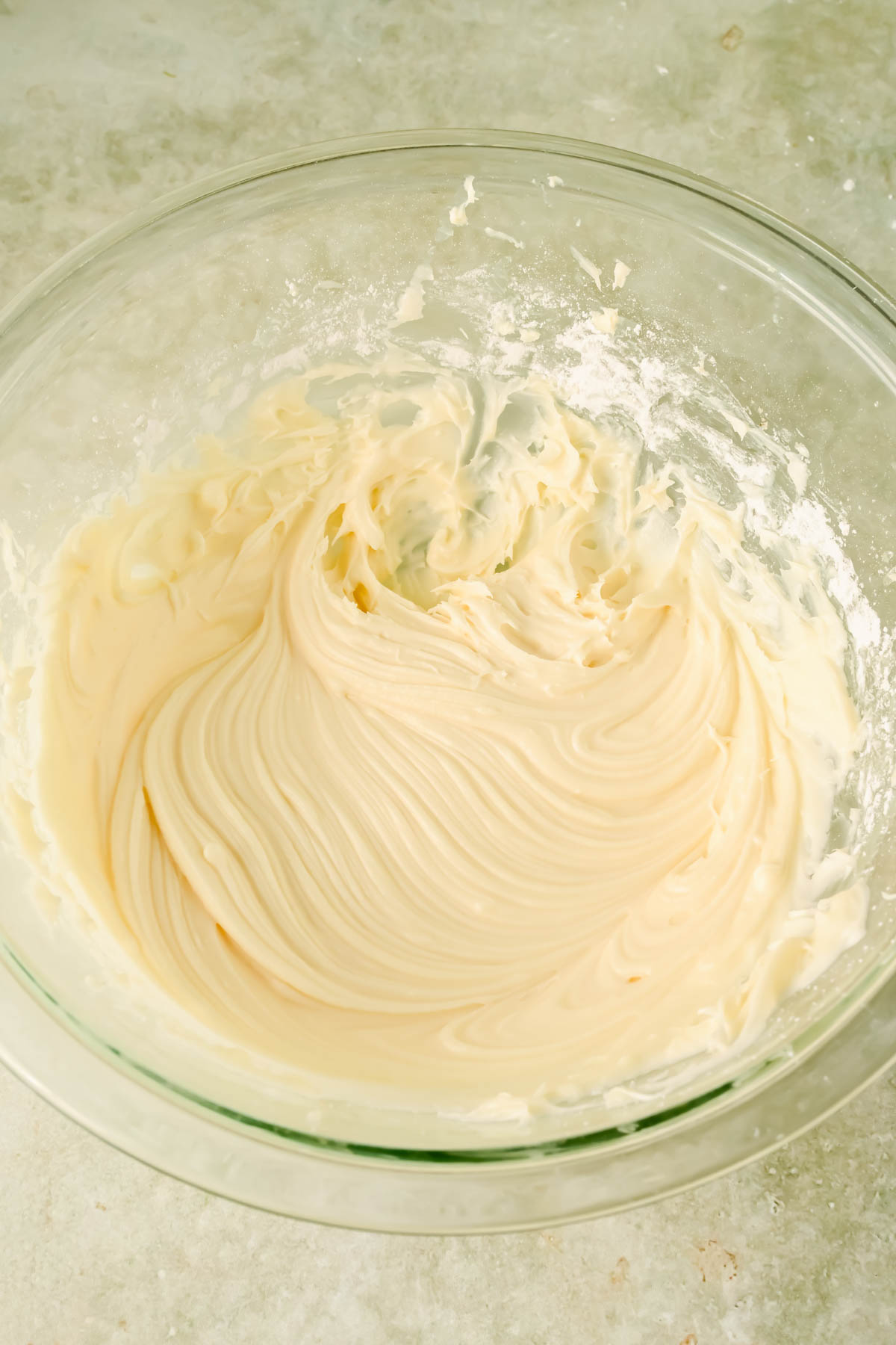 cream cheese frosting whipped in glass mixing bowl.