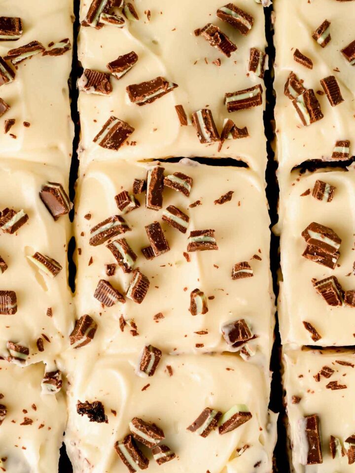 frosted andes mint brownies sliced into squares with chopped andes mints on top.