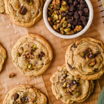 pistachio chocolate chip cookies on parchment lined cooling rack.