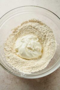 flour mixture and greek yogurt in large glass mixing bowl.
