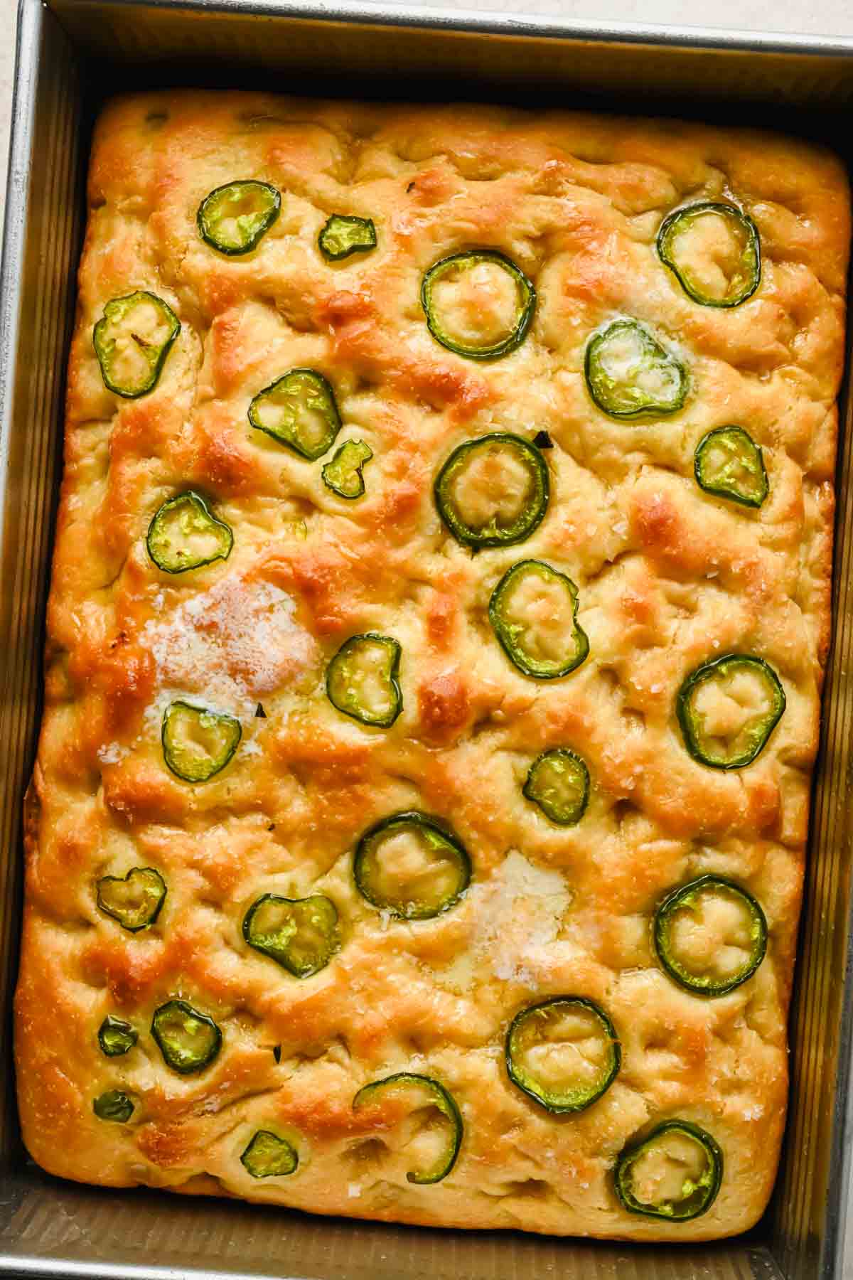 honey jalapeno cornbread with golden brown top in rectangular baking tray.