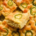 honey jalapeno cornbread cut into squares in large backing tray.