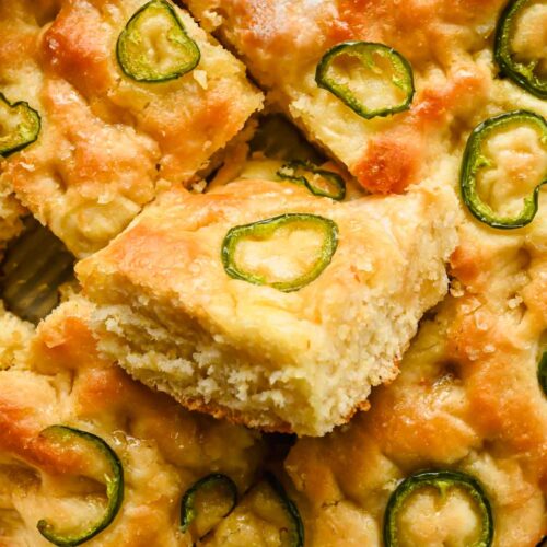 honey jalapeno cornbread cut into squares in large backing tray.