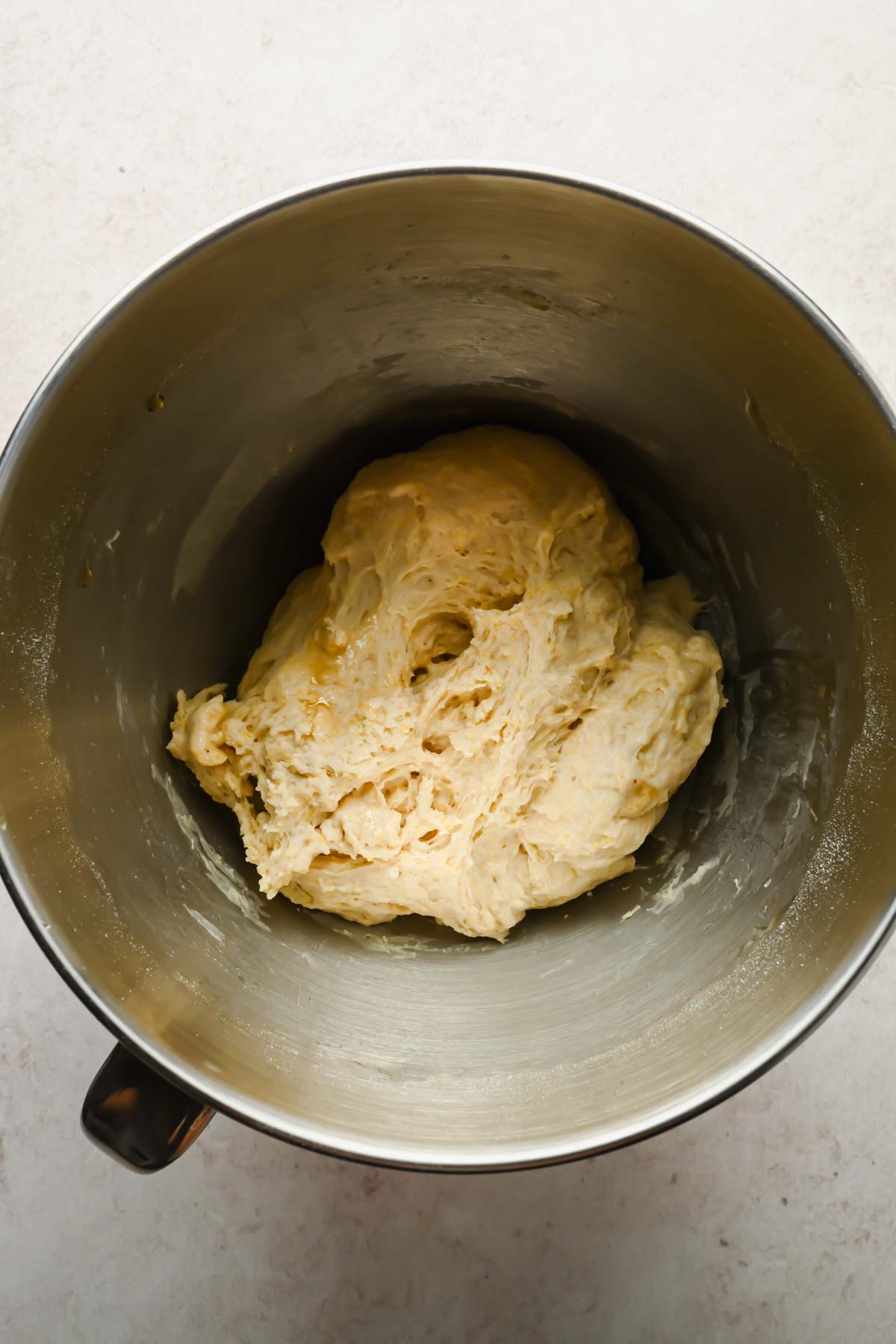 raw focaccia cornbread dough in bowl of stand mixer.