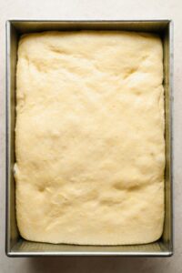 raw cornbread dough in baking dish before baking.