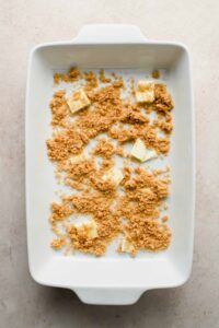 butter pats and brown sugar spread in white baking tray.