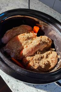 raw, seasoned turkey tenderloins, carrots and onions in large crock pot.
