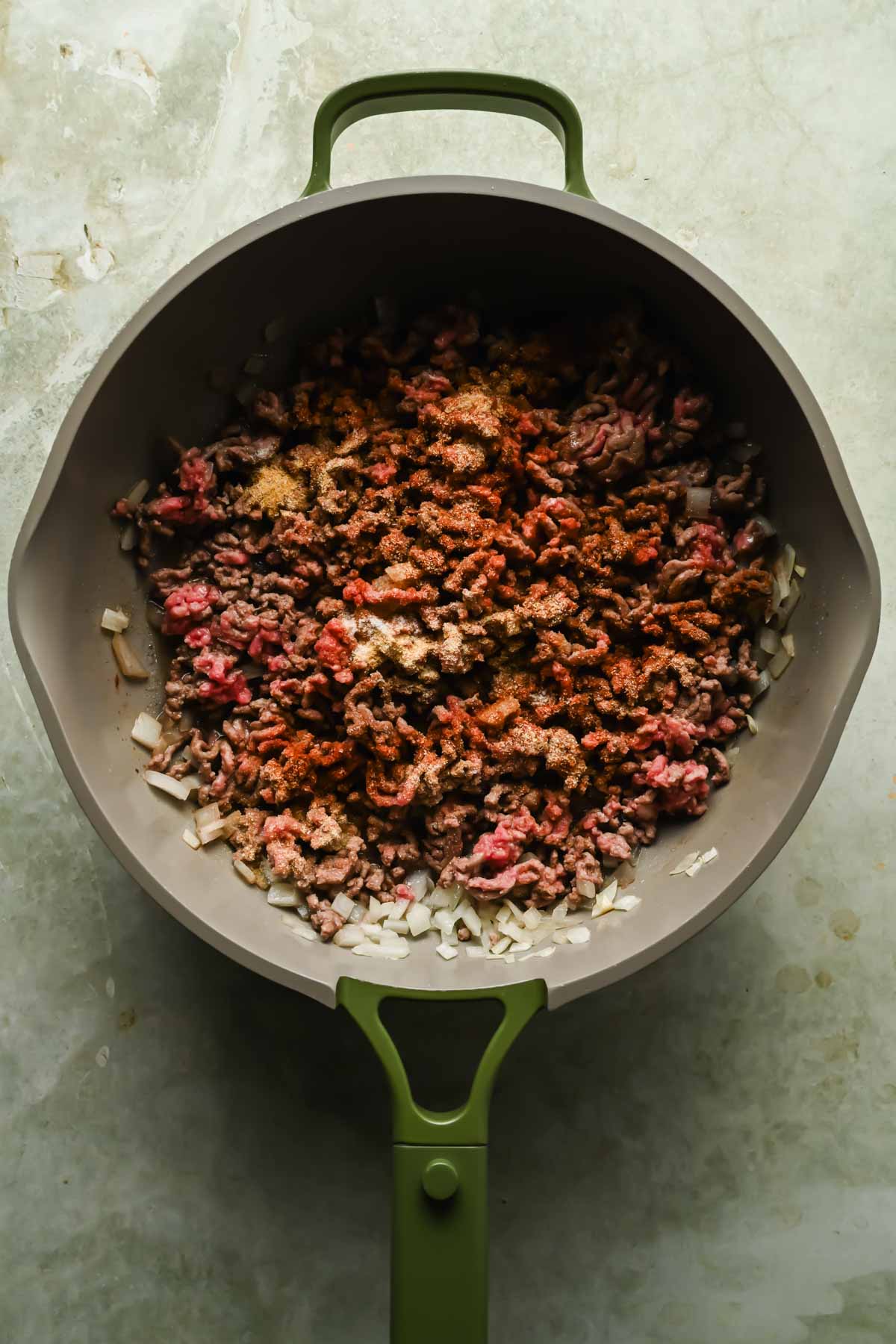ground beef, onions and spices cooking in large skillet.