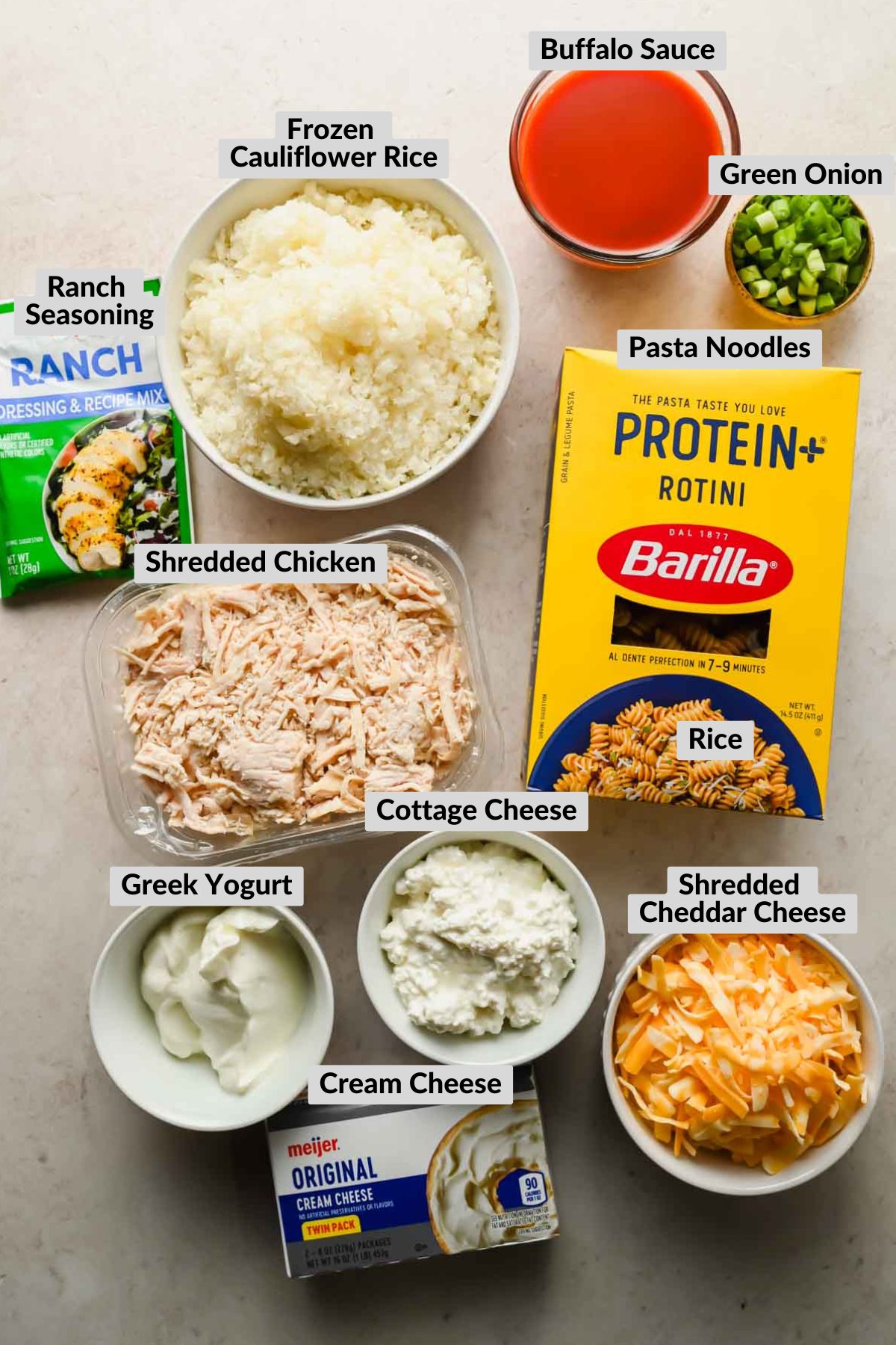ingredients for baked buffalo chicken casserole in individual bowls.
