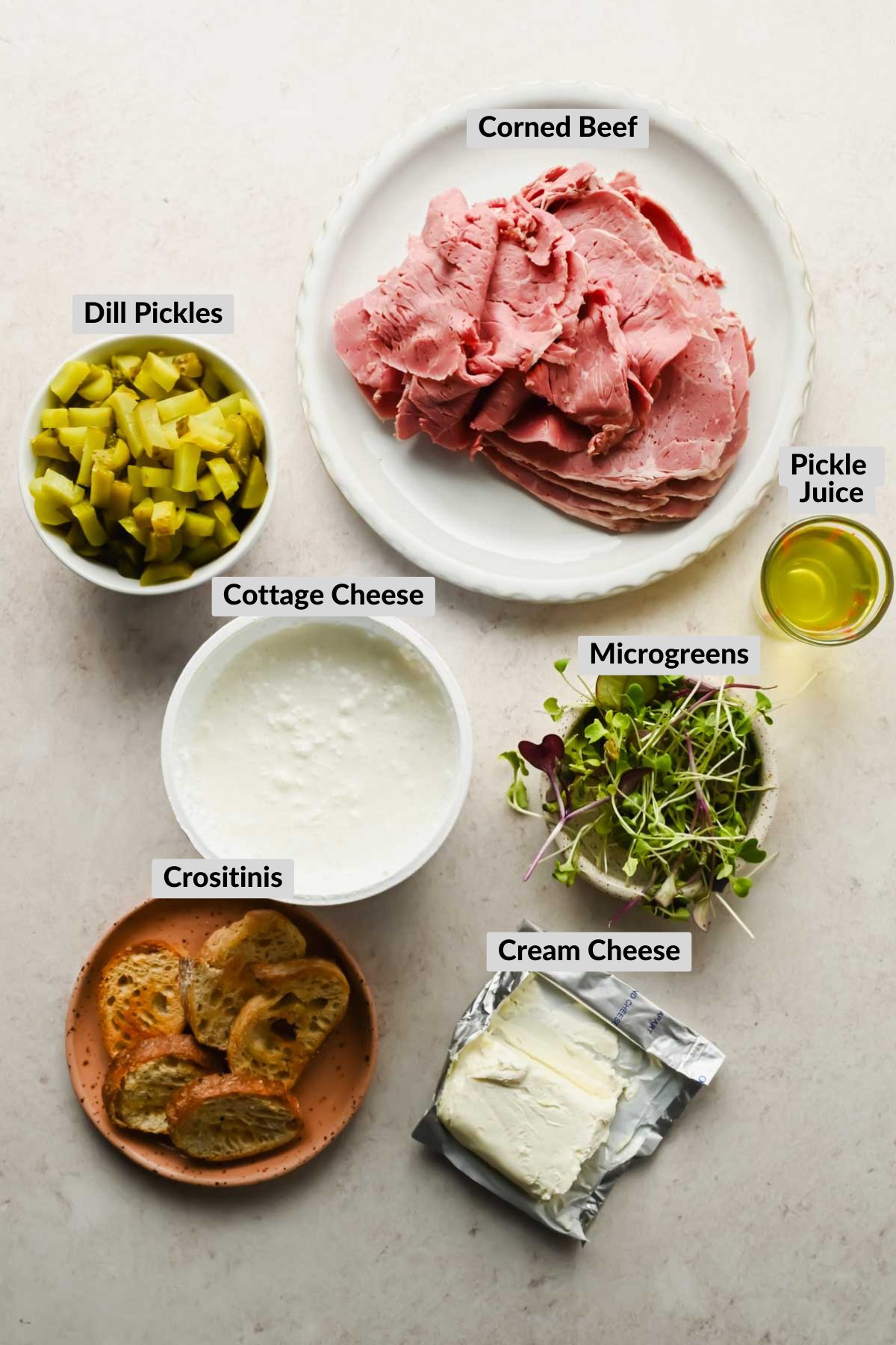 labeled ingredients for corned beef dip in individual bowls.