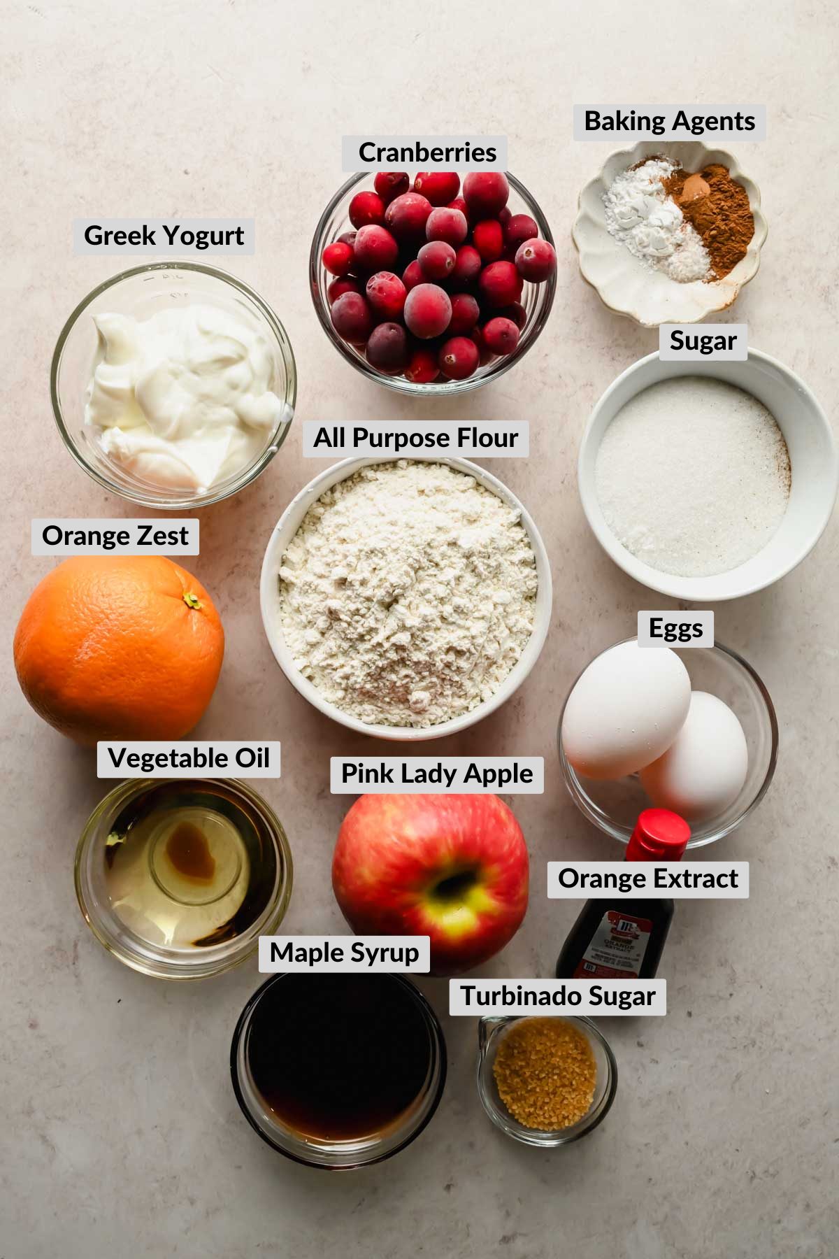 labeled ingredients for cranberry apple muffins in individual bowls.