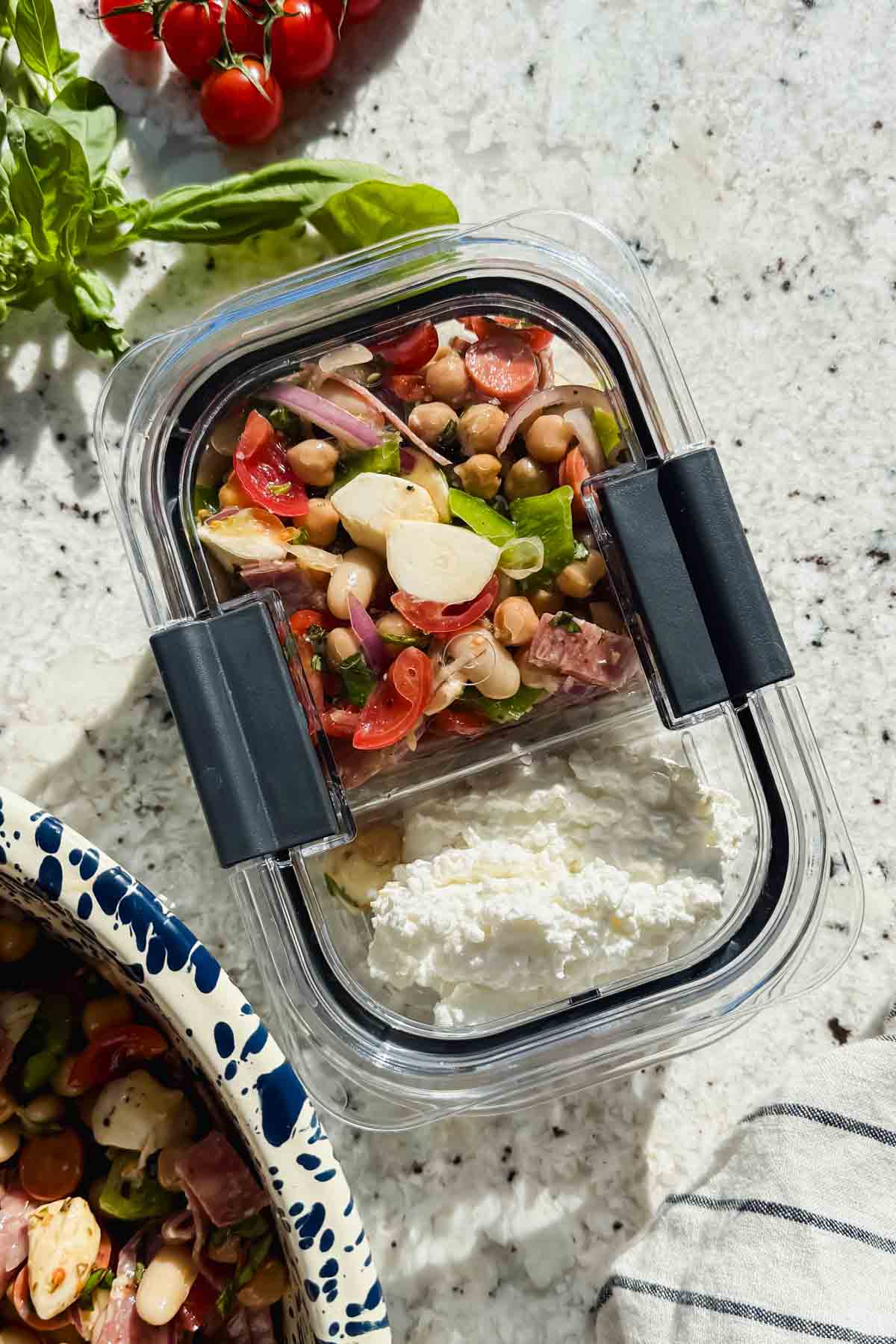 dense bean salad with side of cottage cheese in meal prep container.