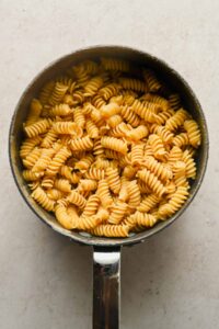 Fusilli noodles cooked in large sauce pot.