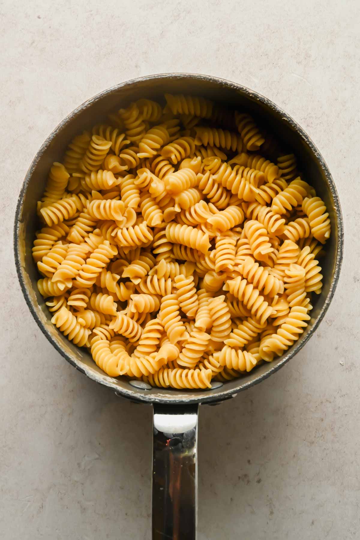Fusilli noodles cooked in large sauce pot.