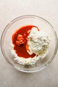 cream cheese, cottage cheese and buffalo sauce in large glass mixing bowl.