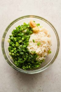 chopped herbs, rice and garlic in large glass mixing bowl.