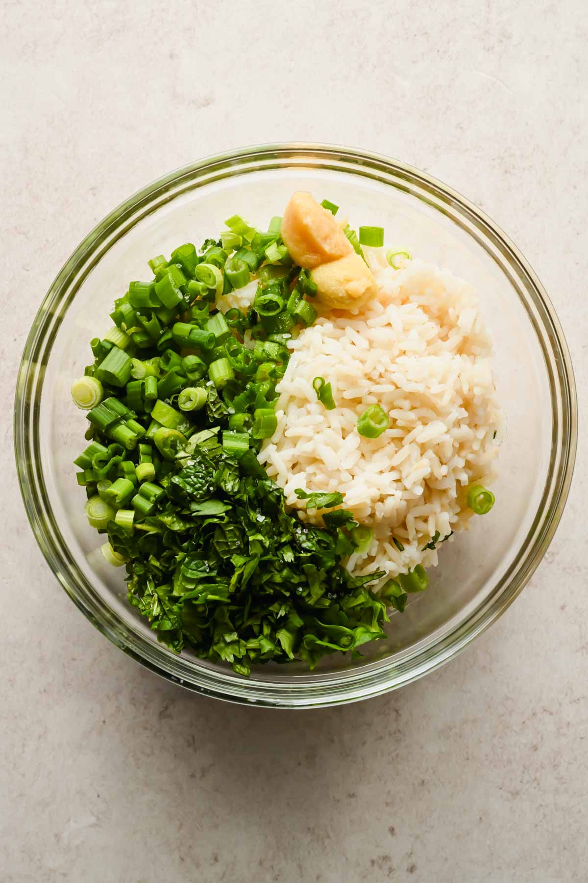 chopped herbs, rice and garlic in large glass mixing bowl.
