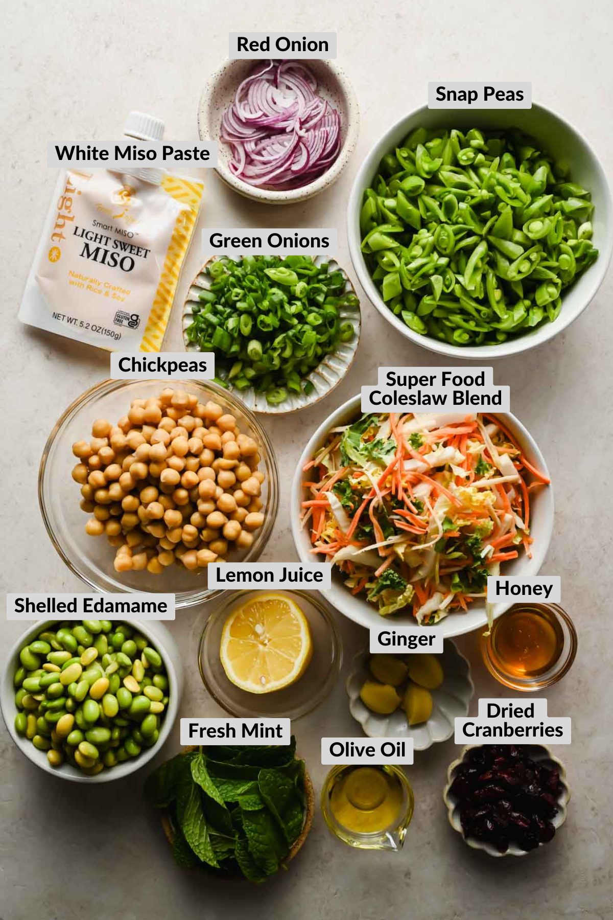 labeled ingredients for edamame salad in individual bowls.