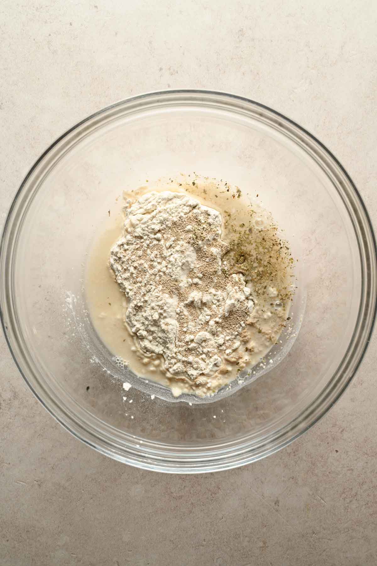 pizza crust ingredients in glass mixing bowl.
