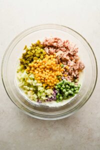 ingredients for Matthew McConaughey Tuna Salad in large glass mixing bowl before mixing.
