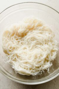cooked vermicelli noodles in large glass bowl.