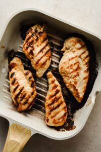cooked chicken breasts in grill pan.
