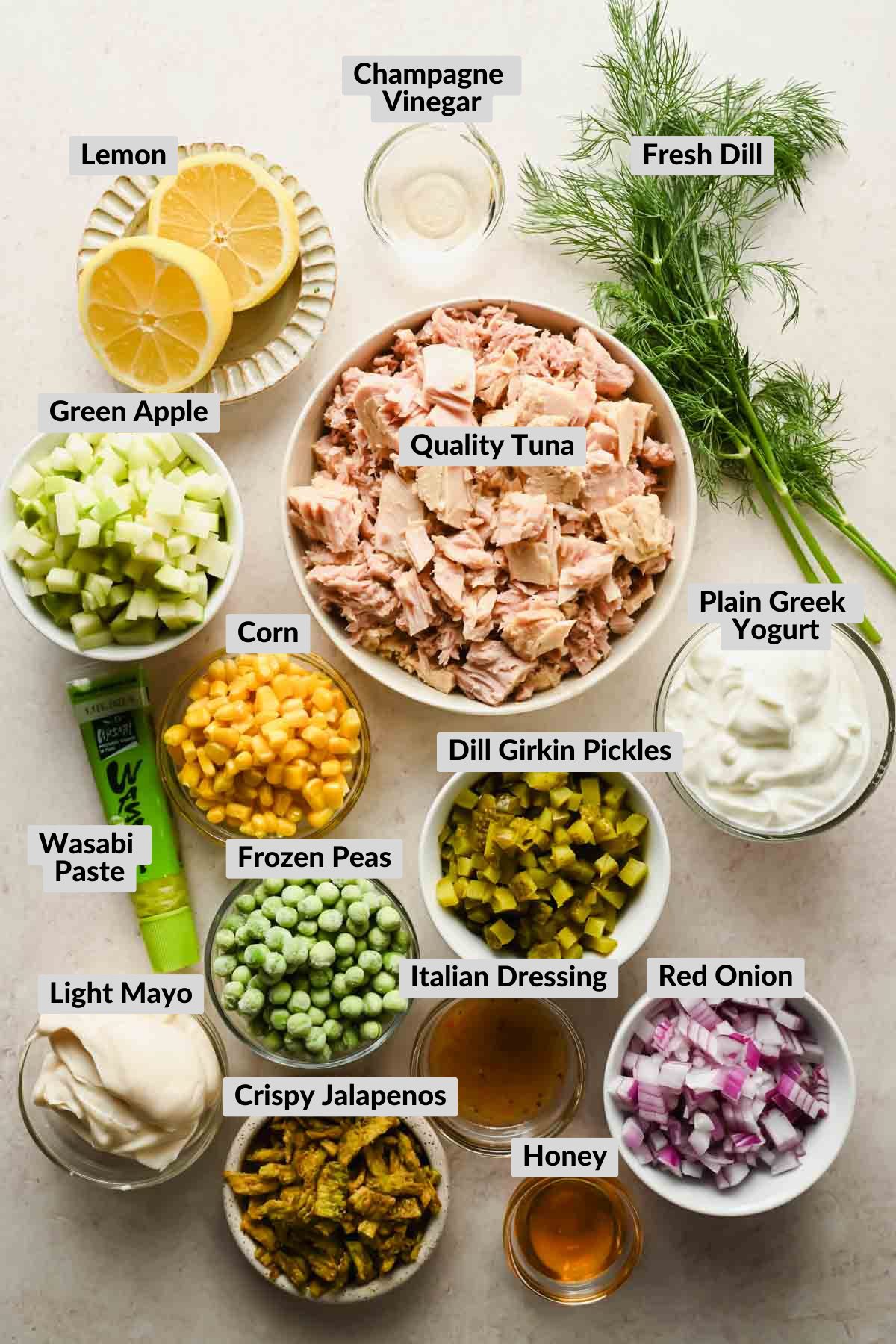 ingredients for Matthew McConaughey Tuna Salad in individual bowls on gold baking sheet.