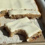 grandma's sheet cake recipe with a cut slice and a bite taken out of it.